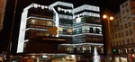 Obchodní dům Kotva Praha večer — rekonstrukce na luxusní obchodní centrum 2028