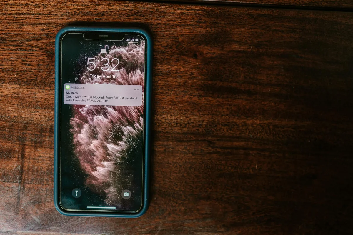 smartphone displaying bank alert warning symbolizing vishing phone fraud