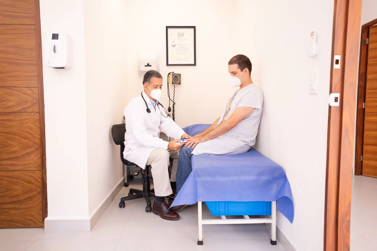 Doctor examines patient during GP visit under Bulgaria NHIF health insurance