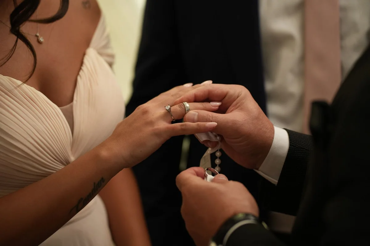 Couple exchanging wedding rings during marriage ceremony in Czech Republic